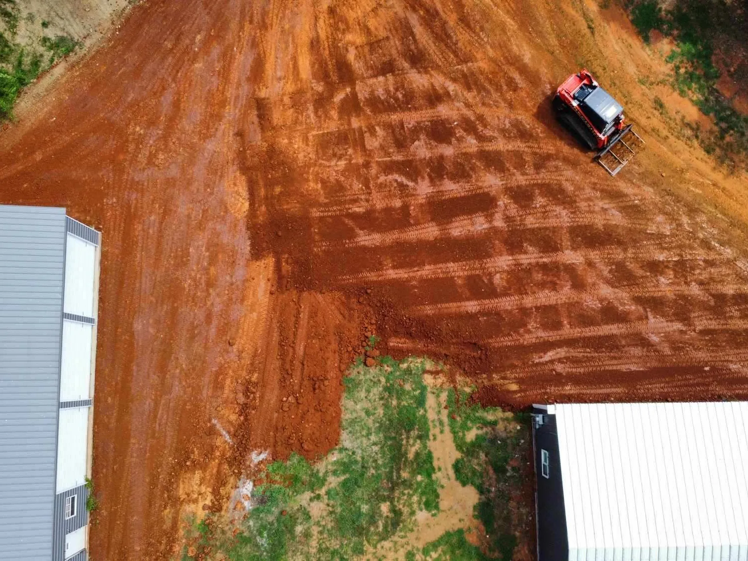 Drone view of a graded pad and drive with clean grade lines