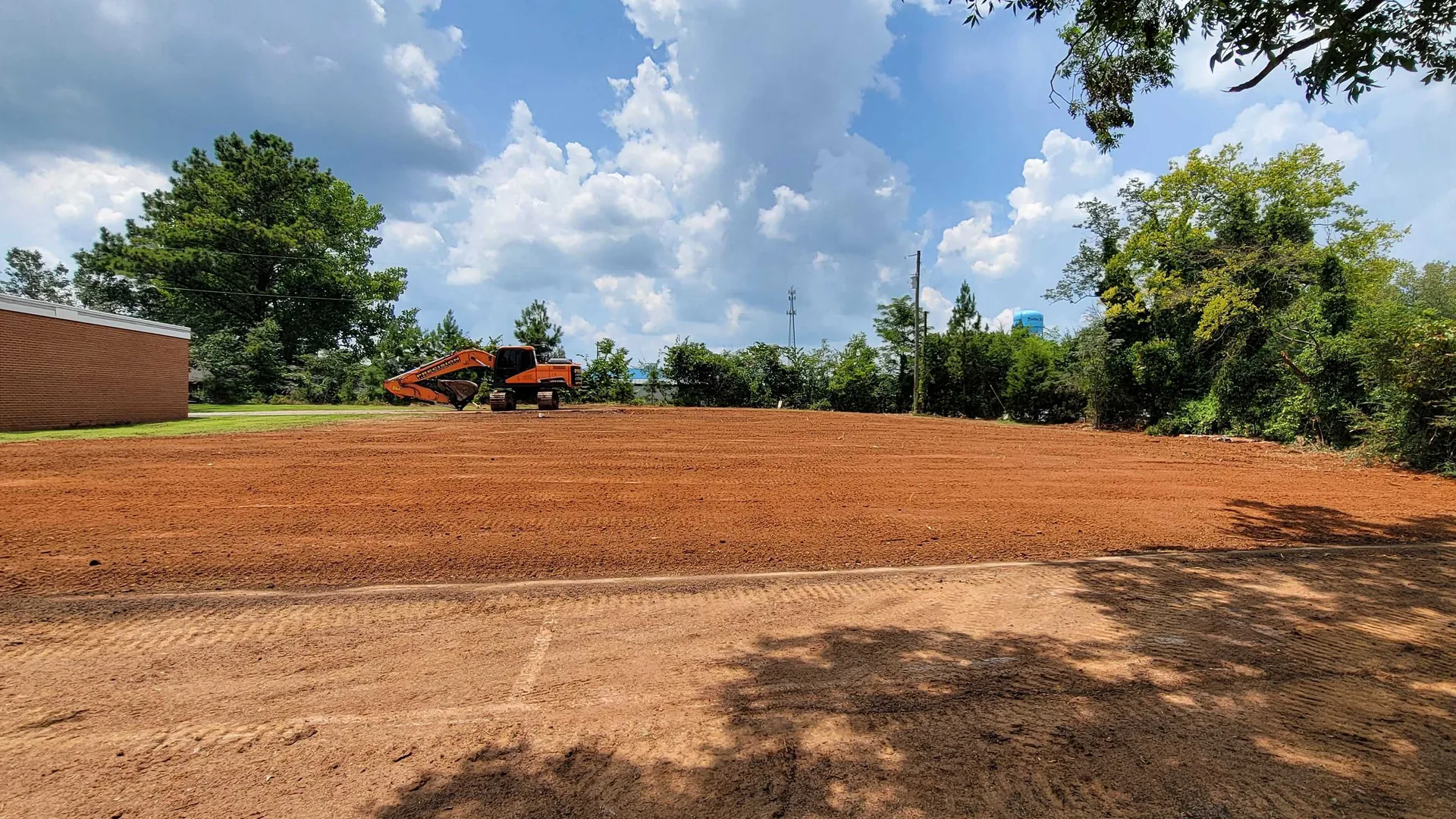 Excavator on a freshly graded building pad in Trinity, Alabama