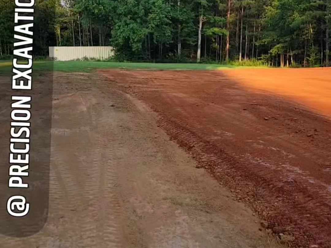 Red clay pad graded to the treeline