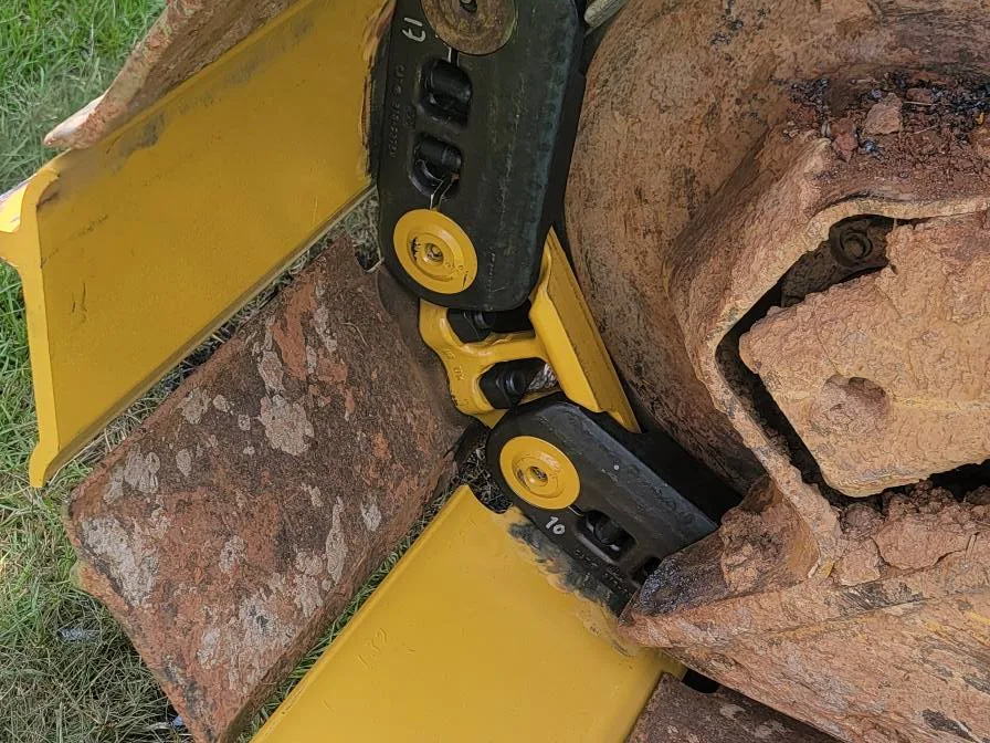 Ripper shank on the trackhoe bucket after a day in rock