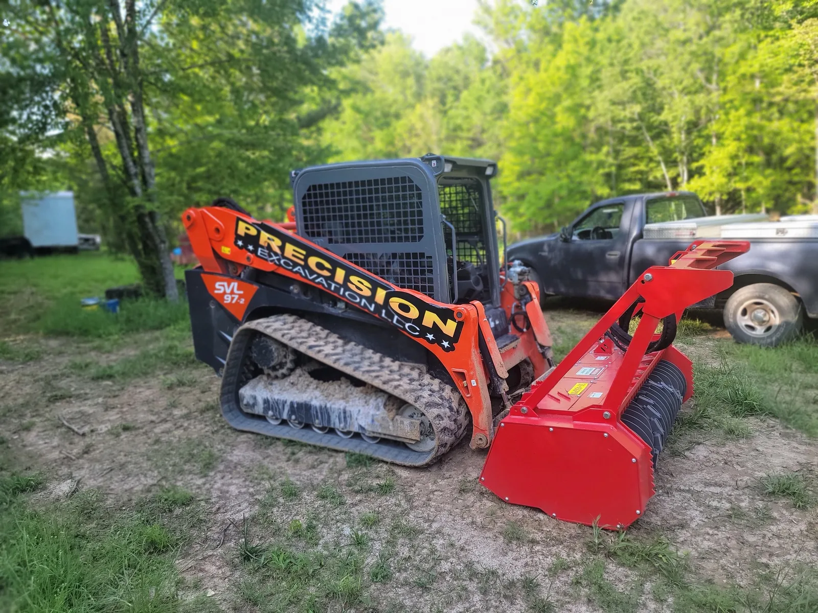 Our skid steer with the mulching head on an overgrown pasture, thorn trees and scrub cedars ground in place