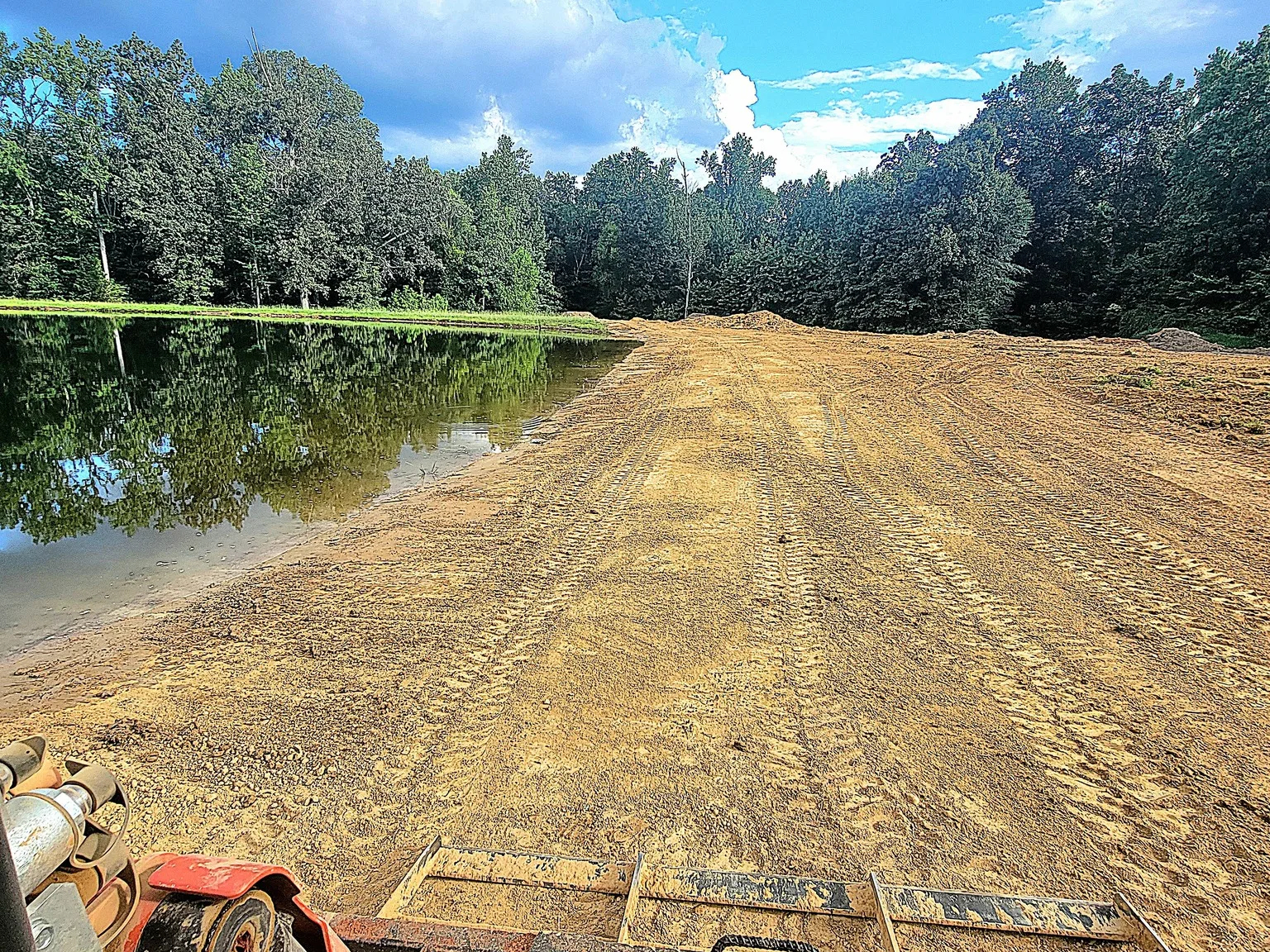 Steep pond bank regraded and cleaned up