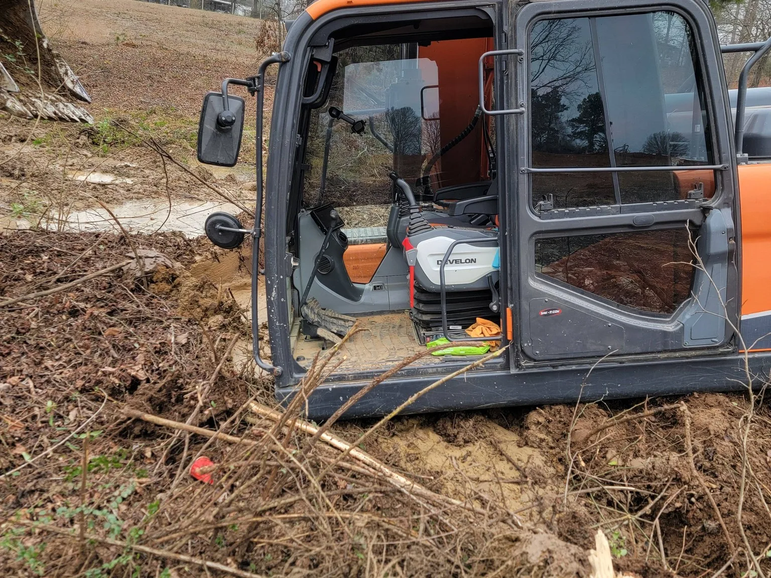 Trackhoe pulling roots on a swamp clearing job