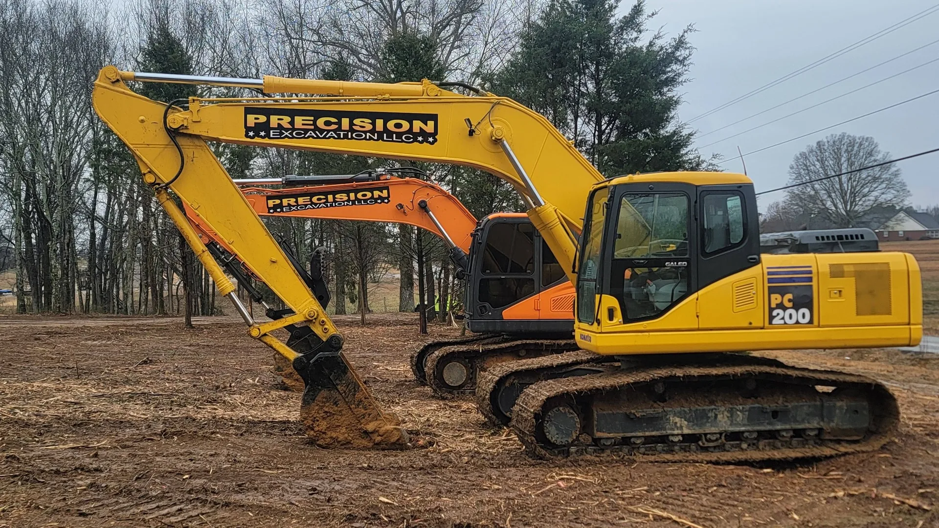 Two of our lettered trackhoes on a dirt job